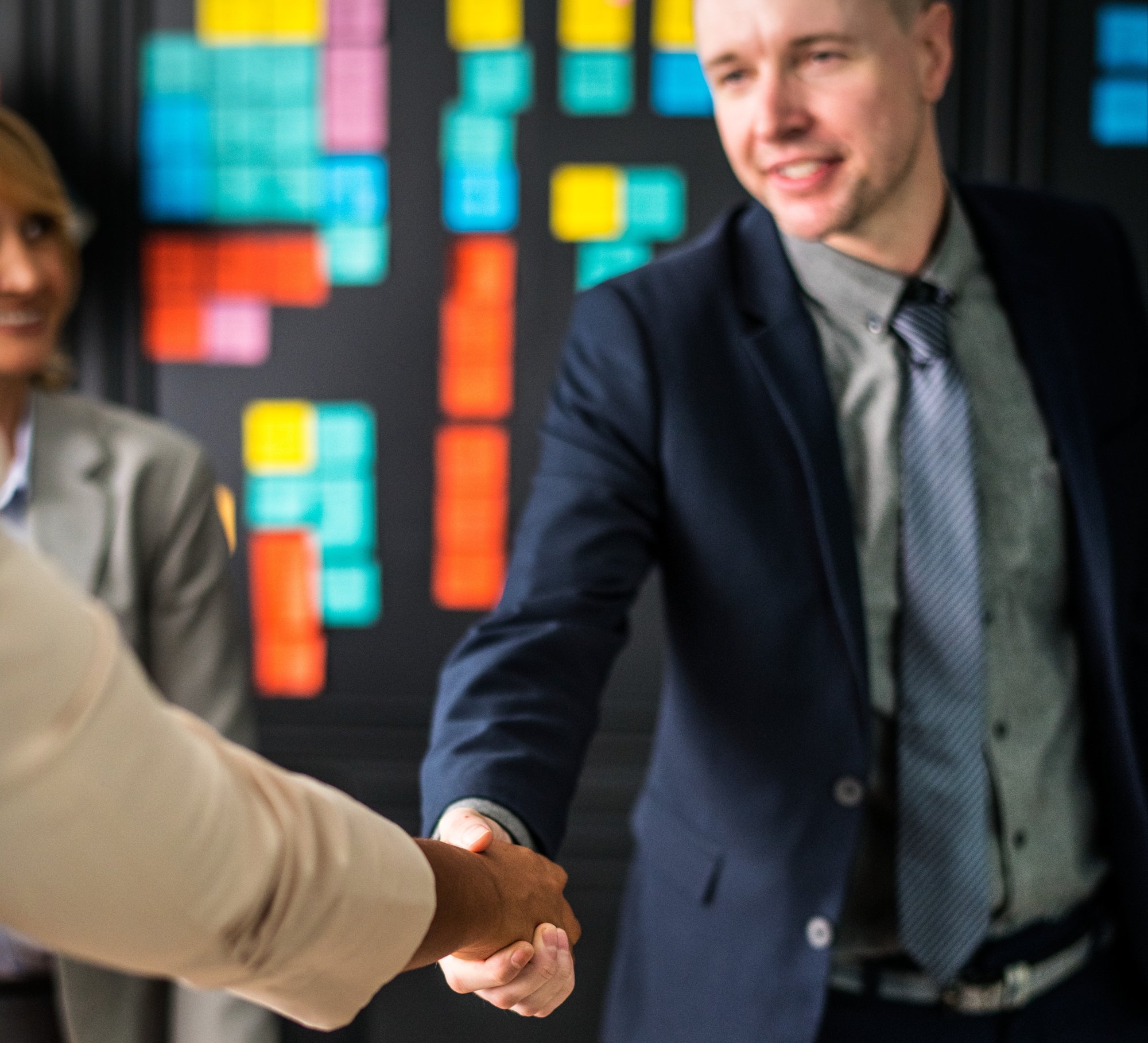 business-people-shaking-hands-meeting-room